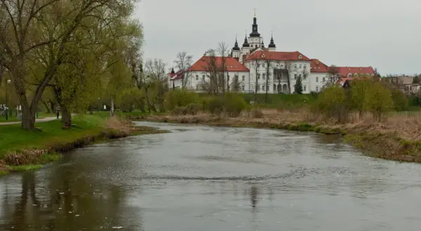 Rzeka Narew płynie obok klasztoru Bazylianów, jednego z głównych supraśl atrakcji. Wiosna budzi zieleń drzew.
