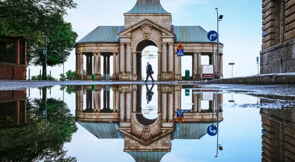 Odbicie zabytkowej budowli w kałuży po deszczu. Warto zobaczyć to miejsce w Szczecinie, szczególnie po opadach.