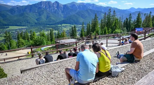 Widok na Tatry z widowni, gdzie ludzie odpoczywają, ciesząc się atrakcjami Poronina.