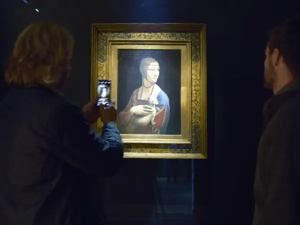 Dama z gronostajem w Muzeum Książąt Czartoryskich w Krakowie. Kobieta robi zdjęcie obrazu telefonem.